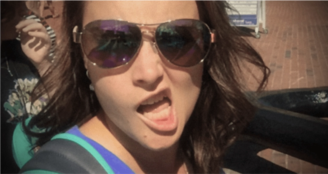 A woman with black hair wearing sunglasses.