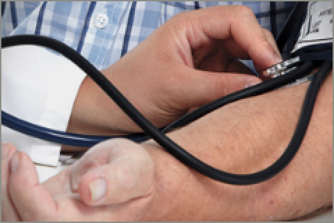 Close up image of a doctor checking the pulse of a patient.