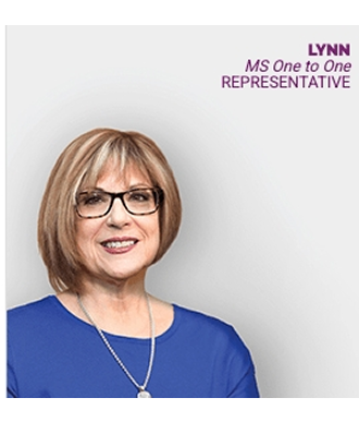 Lynn, MS One to One Representative, wearing a blue top and a necklace in front of a white background.